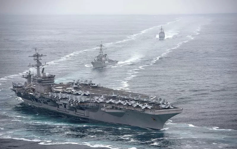 This US Navy photo obtained August 4, 2019 shows the aircraft carrier USS Theodore Roosevelt (CVN 71), front, the Arleigh Burke-class guided-missile destroyer USS Russell (DDG 59), center, and the Ticonderoga-class guided-missile cruiser USS Bunker Hill (CG 52) transit in formation on July 31, 2019 in the Pacific Ocean. - Theodore Roosevelt, Russell and Bunker Hill are conducting routine operations in the eastern Pacific Ocean. (Photo by Anthony J. RIVERA / Navy Office of Information / AFP) / RESTRICTED TO EDITORIAL USE - MANDATORY CREDIT "AFP PHOTO / US NAVY/ANTHONY J. RIVERA/HANDOUT" - NO MARKETING - NO ADVERTISING CAMPAIGNS - DISTRIBUTED AS A SERVICE TO CLIENTS