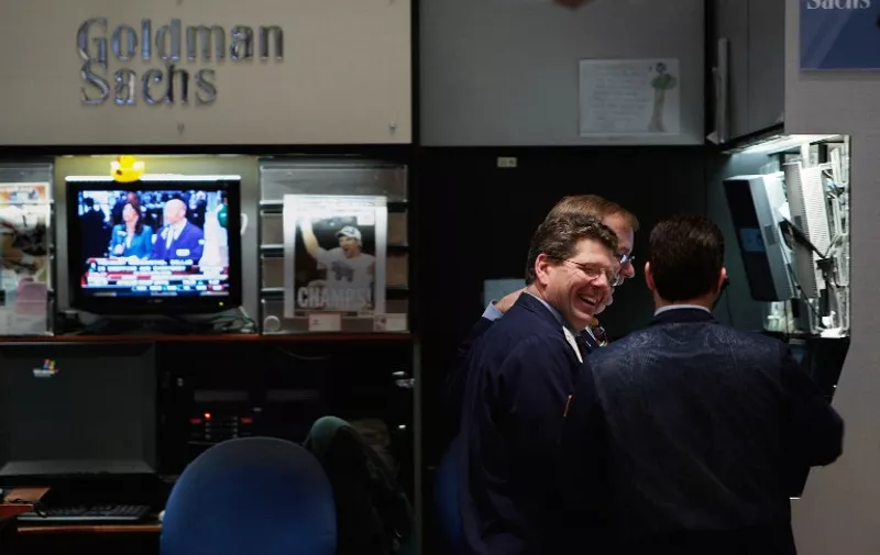 NEW YORK - DECEMBER 16: (FILE PHOTO) Financial professionals laugh in the Goldman Sachs booth on the floor of the New York Stock Exchange during afternoon trading December 16, 2008 in New York City. Goldman Sachs posted a quarterly profit of 3.19 billion October 15, 2009.   Chris Hondros/Getty Images/AFP