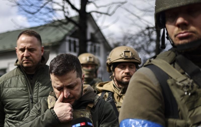 President Volodymyr Zelensky (2nd L) walks in the town of Bucha, just northwest of the Ukrainian capital Kyiv on April 4, 2022. - Ukraine's President Volodymyr Zelensky said on April 3, 2022 the Russian leadership was responsible for civilian killings in Bucha, outside Kyiv, where bodies were found lying in the street after the town was retaken by the Ukrainian army. (Photo by RONALDO SCHEMIDT / AFP)
