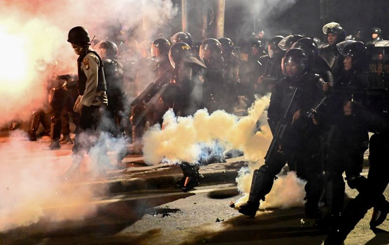 Indonesian police shoot tear gas to disperse protesters during a demonstration outside the Elections Oversight Body (Bawaslu) in Jakarta on May 22, 2019. - Heavily armed Indonesian troops were on high alert amid fears of civil unrest in the capital Jakarta, as the surprise early announcement of official election results handed Joko Widodo another term as leader of the world's third-biggest democracy. (Photo by BAY ISMOYO / AFP)