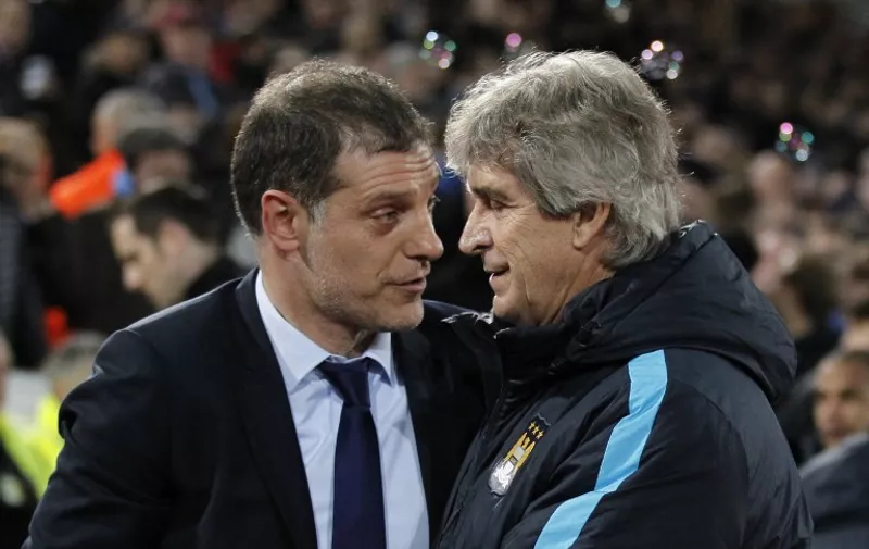 Manchester City's Chilean manager Manuel Pellegrini (R) is greeted by West Ham United's Croatian manager Slaven Bilic (L) for the English Premier League football match between West Ham United and Manchester City at The Boleyn Ground in Upton Park, in east London on January 23, 2016. AFP PHOTO / IKIMAGES

RESTRICTED TO EDITORIAL USE. No use with unauthorised audio, video, data, fixture lists, club/league logos or "live" services. Online in-match use limited to 45 images, no video emulation. No use in betting, games or single club/league/player publications. / AFP / IKIMAGES / IKIMAGES
