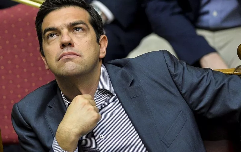 Greek Prime Minister Alexis Tsipras takes part in a session at the Greek Parliament in Athens on July 10, 2015. Lawmakers in Greece are to vote whether to back a last-ditch reform plan the government submitted to creditors overnight in a bid to stave off financial collapse and exit from the Eurozone. Greece's international creditors believe its latest debt proposals are positive enough to be the basis for a new bailout worth 74 billion euros, an EU source said June 10. . AFP PHOTO / ANDREAS SOLARO