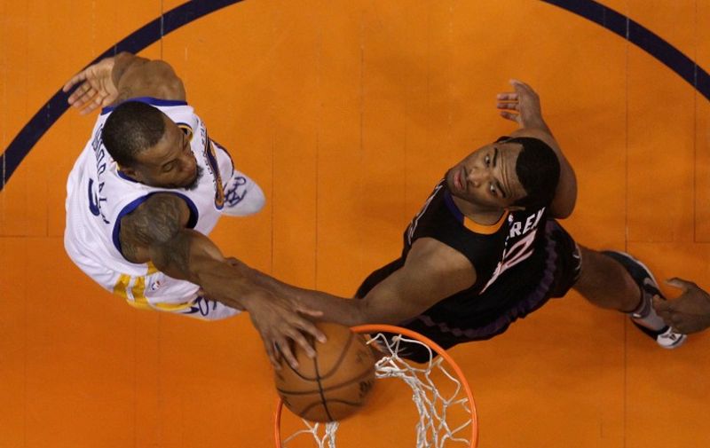 PHOENIX, AZ - NOVEMBER 27: Andre Iguodala #9 of the Golden State Warriors slam dunks the ball over T.J. Warren #12 of the Phoenix Suns during the second half of the NBA game at Talking Stick Resort Arena on November 27, 2015 in Phoenix, Arizona. The Warriors defeated the Suns 135-116. NOTE TO USER: User expressly acknowledges and agrees that, by downloading and or using this photograph, User is consenting to the terms and conditions of the Getty Images License Agreement.   Christian Petersen/Getty Images/AFP