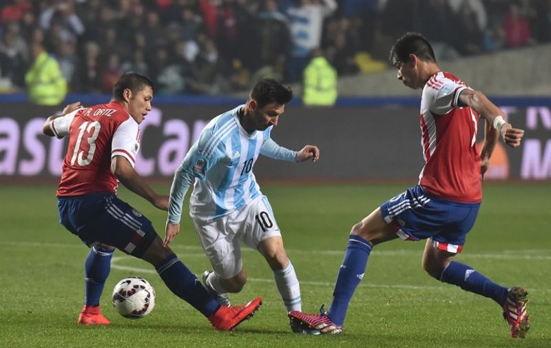 Paraguay's midfielder Richard Ortiz (L) and Paraguay's defender Bruno Valdez (R) vie for the ball with Argentina's forward Lionel Messi during their Copa America semifinal football match in Concepcion, Chile on June 30, 2015.  AFP PHOTO / NELSON ALMEIDA