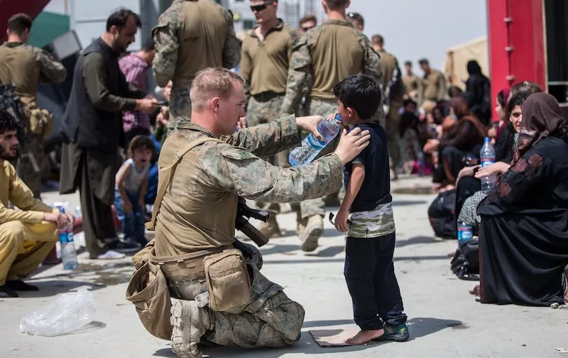 A United States Marine with the 24th Marine Expeditionary Unit (MEU) provides fresh water to a child during an evacuation at Hamid Karzai International Airport, Kabul, Afghanistan,. US service members are assisting the US Department of State with an orderly drawdown of designated personnel in Afghanistan. Mandatory
Evacuation at Hamid Karzai International Airport, Kabul, AFG - 20 Aug 2021,Image: 628118007, License: Rights-managed, Restrictions: ***
HANDOUT image or SOCIAL MEDIA IMAGE or FILMSTILL for EDITORIAL USE ONLY! * Please note: Fees charged by Profimedia are for the Profimedia's services only, and do not, nor are they intended to, convey to the user any ownership of Copyright or License in the material. Profimedia does not claim any ownership including but not limited to Copyright or License in the attached material. By publishing this material you (the user) expressly agree to indemnify and to hold Profimedia and its directors, shareholders and employees harmless from any loss, claims, damages, demands, expenses (including legal fees), or any causes of action or allegation against Profimedia arising out of or connected in any way with publication of the material. Profimedia does not claim any copyright or license in the attached materials. Any downloading fees charged by Profimedia are for Profimedia's services only. * Handling Fee Only 
***, Model Release: no, Credit line: Profimedia