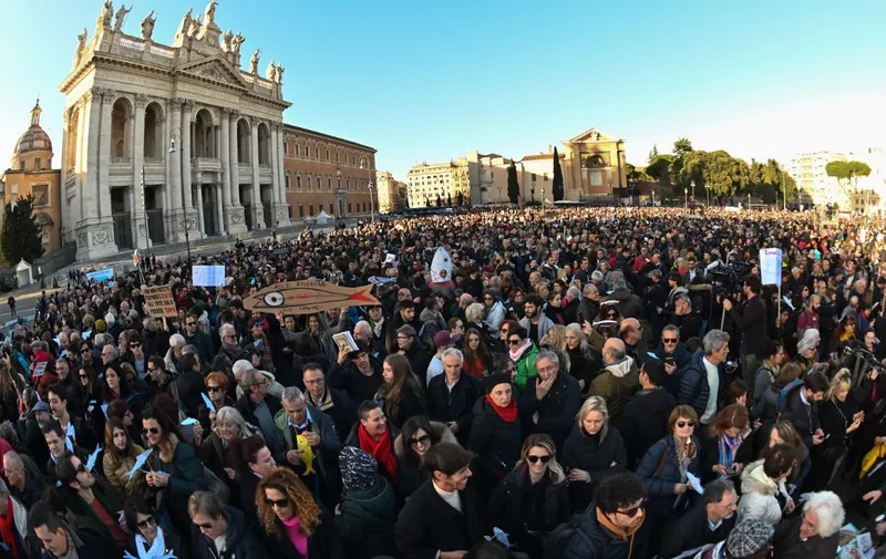 People take part in a demonstration of the "Sardine Movement", formed to oppose the far-right League party, on December 14, 2019 by the Basilica San Giovanni in Laterano in Rome. - Italy's youth-driven "Sardine Movement", formed to oppose the far-right League party, was launched by four little-known youths saying the anti-immigration League party led by Matteo Salvini represents hate and exclusion. The sardine has become a symbol of protest against Salvini, a former interior minister. (Photo by ANDREAS SOLARO / AFP)