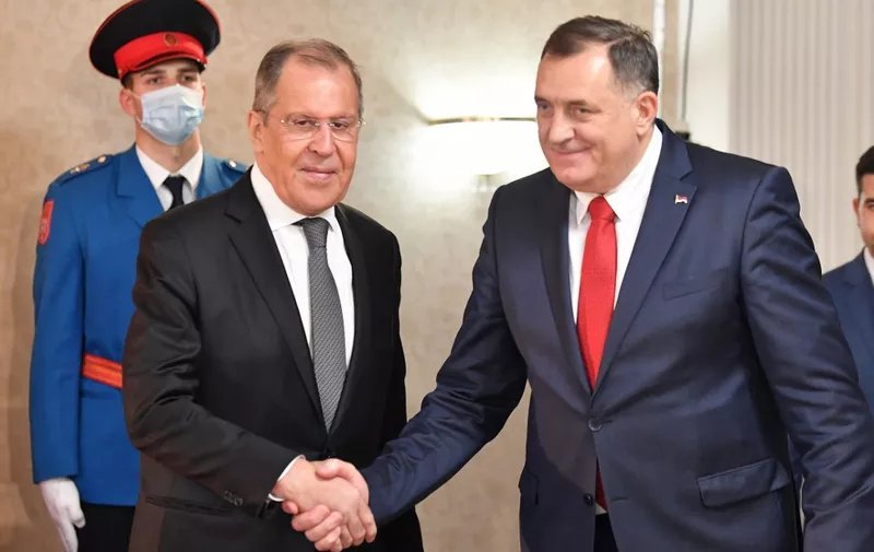 Russian Foreign Minister, Sergey Lavrov (L) shakes hands after meeting with chairman of Bosnia and Herzegovina's tripartite presidency, Milorad Dodik (R), in East-Sarajevo, late on December 14, 2020. - Minister Lavrov arrived in two-day official visit to Bosnia and Herzegovina, where he is scheduled to hold several meetings with country's top officials. (Photo by ELVIS BARUKCIC / AFP)