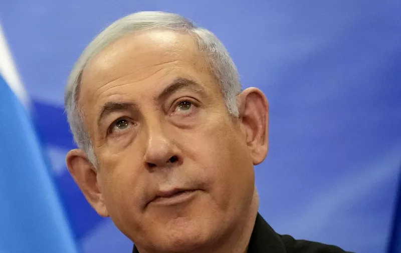 Israeli Prime Minister Benjamin Netanyahu looks on as he addresses media during a joint press conference with French President in Jerusalem on October 24, 2023. Macron's visit comes more than two weeks after Hamas militants stormed into Israel from the Gaza Strip and killed at least 1,400 people, according to Israeli officials while Israel continues a relentless bombardment of the Gaza Strip and prepares for a ground offensive with more than 5,000 Palestinians, mainly civilians, killed so far across the Palestinian territory, according to the latest toll from the Hamas health ministry in Gaza. (Photo by Christophe Ena / POOL / AFP)