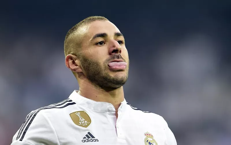 Real Madrid's French forward Karim Benzema sticks out his tongue during the UEFA Champions League semi-final second leg football match Real Madrid FC vs Juventus at the Santiago Bernabeu stadium in Madrid on May 13, 2015.   AFP PHOTO/ GERARD JULIEN