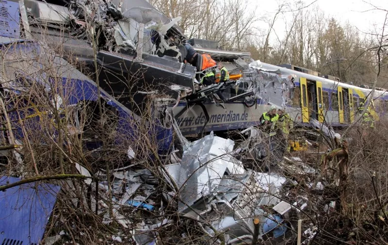 Firefighters and emergency doctors work at the site of a train accident near Bad Aibling, southern Germany, on February 9, 2016.
Two Meridian commuter trains operated by Transdev collided head-on near Bad Aibling, around 60 kilometres (40 miles) southeast of Munich, killing at least eight people and injuring around 100, police said. The cause of the accident was not immediately clear. / AFP / dpa / Josef REISNER / Germany OUT