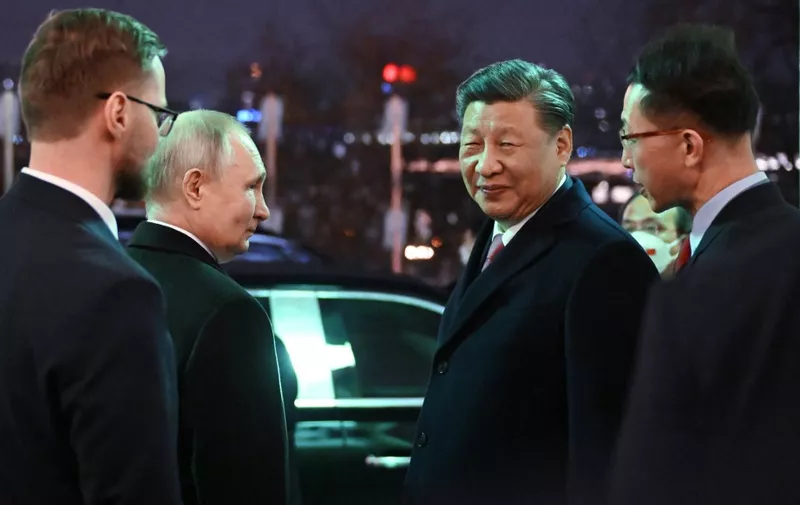 Russian President Vladimir Putin sees off Chinese President Xi Jinping after a reception following their talks at the Kremlin in Moscow on March 21, 2023. (Photo by Grigory SYSOYEV / SPUTNIK / AFP)