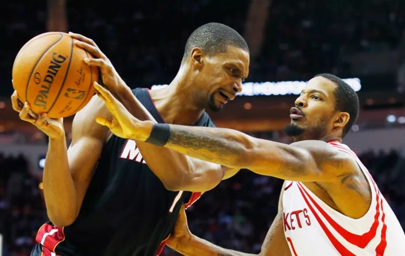 HOUSTON, TX - FEBRUARY 02: Chris Bosh #1 of the Miami Heat looks to drive with the basketball against Trevor Ariza #1 of the Houston Rockets during their game at the Toyota Center on February 2, 2016 in Houston, Texas. NOTE TO USER: User expressly acknowledges and agrees that, by downloading and or using this Photograph, user is consenting to the terms and conditions of the Getty Images License Agreement.   Scott Halleran/Getty Images/AFP