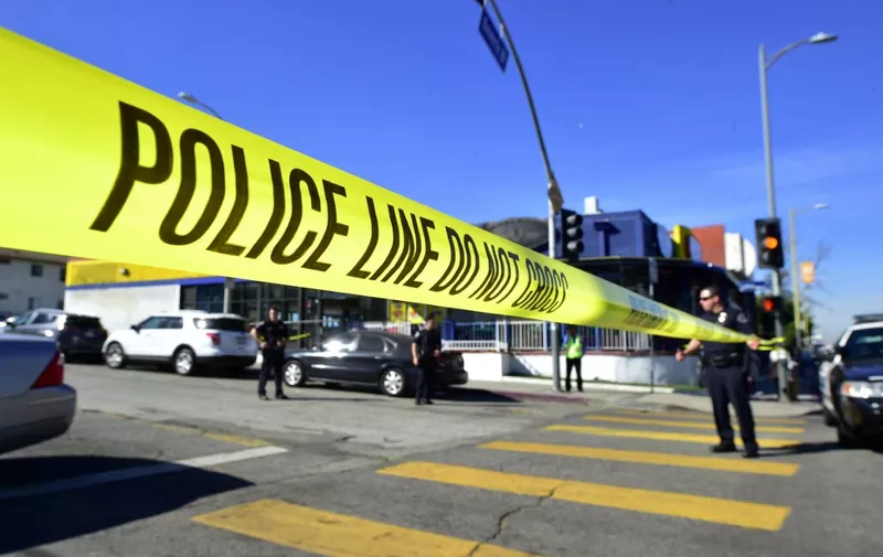Police stand at a roadblock near Salvadore Castro Middle School in Los Angeles, California on February 1, 2018, where two students were wounded, one critically, in a school shooting. - Two 15-year-old students in Los Angeles were shot and wounded in class Thursday, according to witnesses and local media, in the latest school shooting to hit the United States. A boy was shot in the head, while a girl was hit in the wrist, according to reports from the scene. Local news agency CNS reported that a "young woman," possibly a fellow student, had been arrested. (Photo by Frederic J. Brown / AFP)