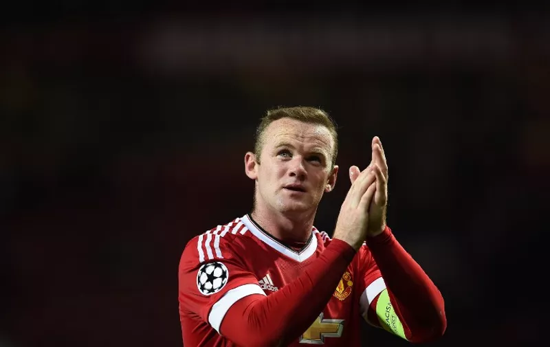 Manchester United's English forward Wayne Rooney applauds the fans as he leaves the pitch following the UEFA Champions League Group B football match between Manchester United and VfL Wolfsburg at Old Trafford in Manchester, north west England, on September 30, 2015.  Manchester United won the match 2-1.   AFP PHOTO / PAUL ELLIS