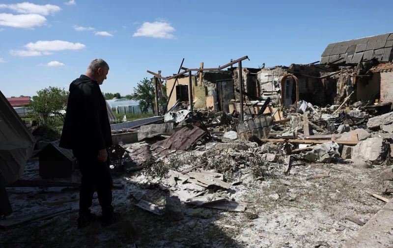 A local resident examines a private house destroyed by a missile attack in the village of Krasylivka, Kyiv region, on May 8, 2024, amid the Russia invasion in Ukraine. (Photo by Anatolii STEPANOV / AFP)