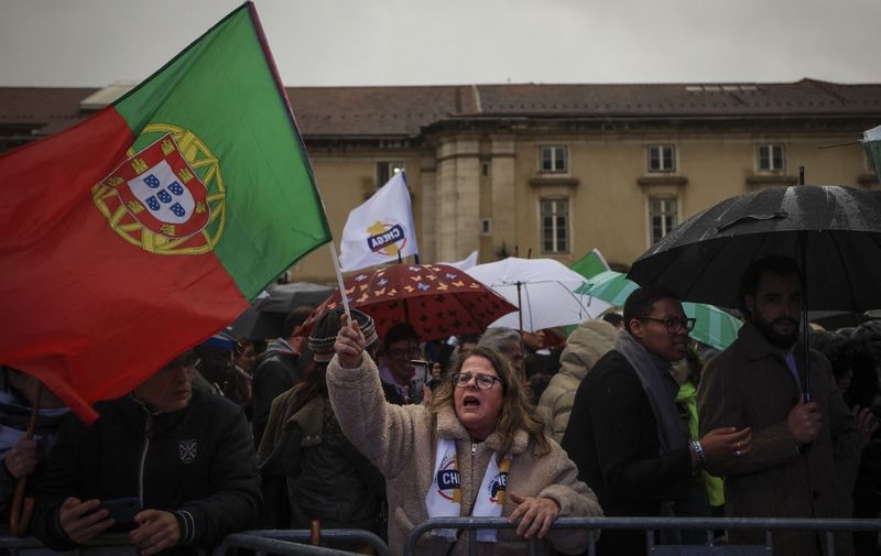 Chega's far-right party supporter waves the Portuguese flag during a rally in Lisbon on March 8, 2024. Portuguese are voting on March 10 for the general elections. (Photo by PATRICIA DE MELO MOREIRA / AFP)
