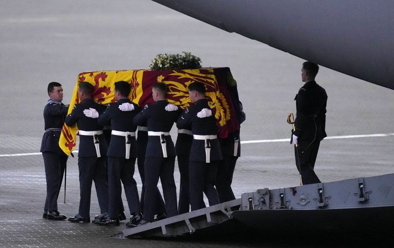 Pallbearers from the Queen's Colour Squadron (63 Squadron RAF Regiment) carry the coffin of Queen Elizabeth II to the Royal Hearse having removed it from the C-17 at the Royal Air Force Northolt airbase on September 13, 2022, before it is taken to Buckingham Palace, to rest in the Bow Room. - Mourners in Edinburgh filed past the coffin of Queen Elizabeth II through the night, before the monarch's coffin returns to London to Lie in State ahead of her funeral on September 19. (Photo by Kirsty Wigglesworth / POOL / AFP)