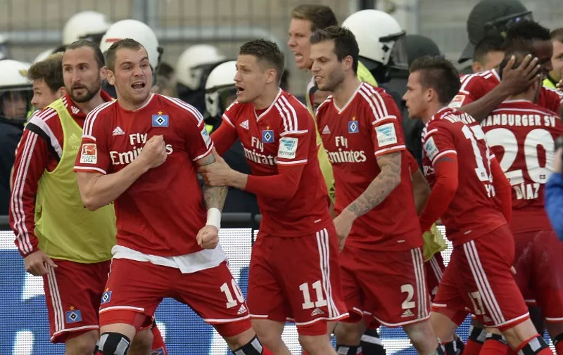Hamburg's players celebrate after Hamburg's Chilean midfielder Marcelo Diaz (R, No 20) scored the 1-1 during the relegation play-off second leg football match of German second division Bundesliga club Karlsruher SC vs German first division Bundesliga club Hamburger SV on June 1, 2015 in Karlsruhe, southern Germany.       AFP PHOTO / THOMAS KIENZLE

RESTRICTIONS - DFL RULES TO LIMIT THE ONLINE USAGE DURING MATCH TIME TO 15 PICTURES PER MATCH. IMAGE SEQUENCES TO SIMULATE VIDEO IS NOT ALLOWED AT ANY TIME. FOR FURTHER QUERIES PLEASE CONTACT DFL DIRECTLY AT + 49 69 650050.