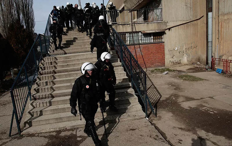 MITROVICA, KOSOVO - FEBRUARY 18:  United Nations police forces watch a Serbian protest rally from an elevated position the day after Kosovo declared independence in the ethnically divided city of Mitrovica February 18, 2008 in Mitrovica, Kosovo.   Kosovo Serbs who live on the north side of town staged a protest against the declaration of independence, and UN and local police forces stood by across the bridge on the south side of town, ready to react to violence.  (Photo by Chris Hondros/Getty Images)