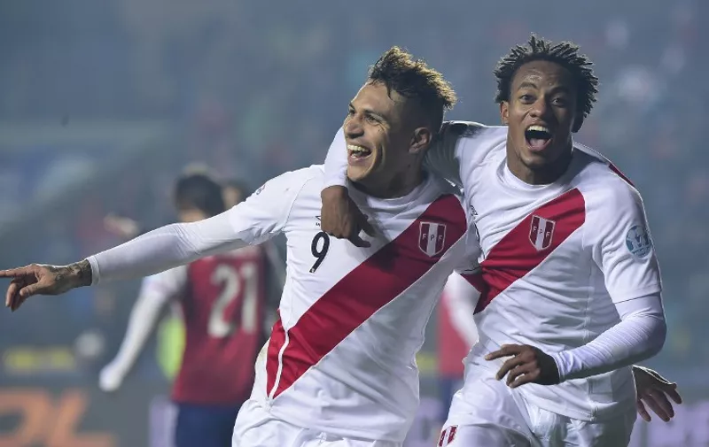 Peru's forward Paolo Guerrero (L) celebrates with teammate Andre Carrillo after scoring against Paraguay during the Copa America third place football match in Concepcion, Chile on July 3, 2015. AFP PHOTO / LUIS ACOSTA