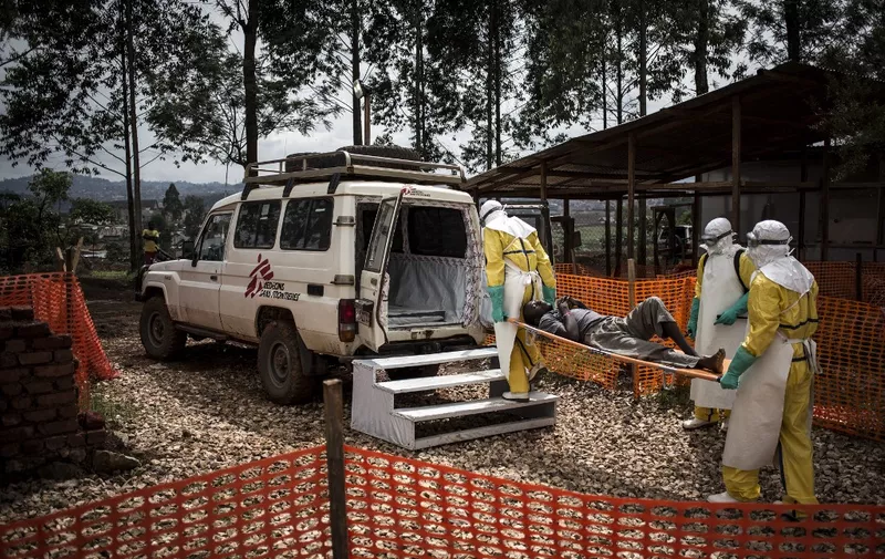 Health workers move a patient to a hospital after he was cleared of having Ebola inside a MSF (Doctors Without Borders) supported Ebola Treatment Centre (ETC) on November 4, 2018 in Butembo, Democratic Republic of the Congo. - The death toll from an Ebola outbreak in eastern Democratic Republic of Congo has risen to more than 200, the health ministry said on November 10, 2018. (Photo by John WESSELS / AFP)