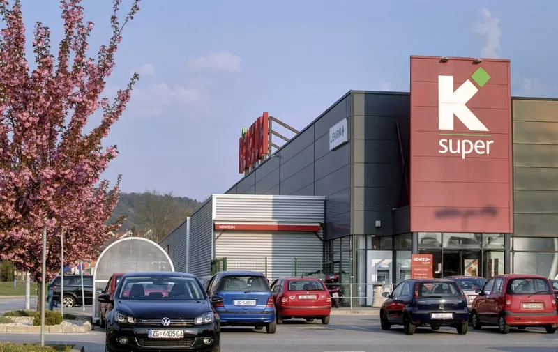 Cars are parkes in front of a building of Konzum, a leading retail chain in Croatia, and part of Agrokor, on April 4, 2017 in Zagreb, Croatia. - Agrokor faced with crushing debt, on March 31, 2017 reached a deal with creditors to help stabilise the troubled company. The crisis within Agrokor, which employs around 60,000 people, two-thirds of them in Croatia, has dominated that country's political agenda for the past few weeks. (Photo by AFP)