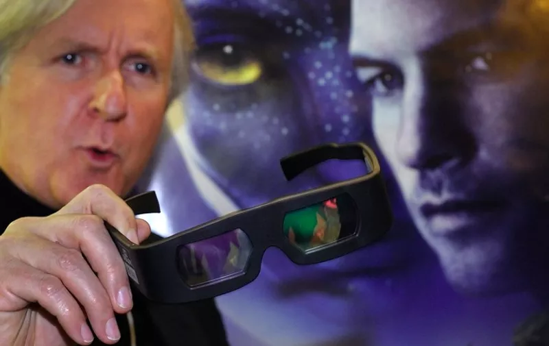 Canadian film director James Cameron shows 3D glasses prior to a show of his movie"Avatar" on the side line of the World Economic Forum (WEF) annual meeting on January 28, 2010 in Davos.  AFP PHOTO / FABRICE COFFRINI