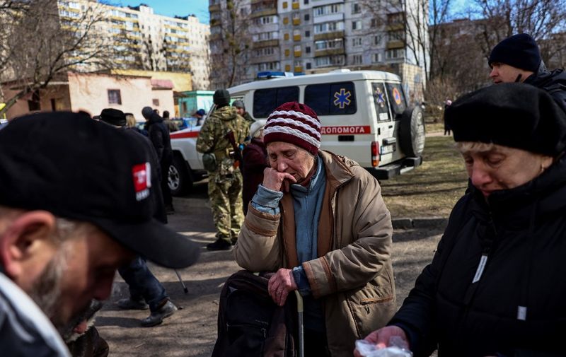 A woman cries in Kyiv after fleeing her home in the outskirts of the city on March 28, 2022, amid Russian invasion of Ukraine. (Photo by RONALDO SCHEMIDT / AFP)