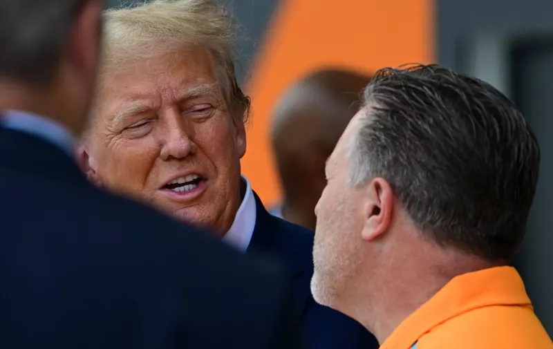 Former US President and 2024 presidential candidate Donald Trump speaks with McLaren Chief Executive Officer Zak Brown (R) during a visit to the McLaren garage ahead of the 2024 Miami Formula One Grand Prix at Miami International Autodrome in Miami Gardens, Florida, on May 5, 2024. (Photo by GIORGIO VIERA / AFP)