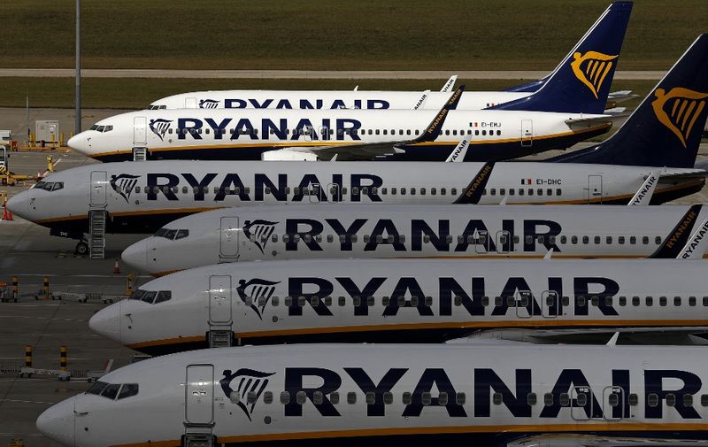Ryanair aircraft are pictured at Stansted airport, northeast of London on August 20, 2020. (Photo by Adrian DENNIS / AFP)