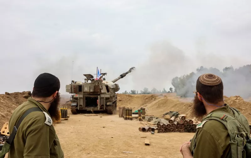 An Israeli artillery unit is pictured near the border with the Gaza Strip on December 5, 2023, amid continuing battles between Israel and the militant group Hamas. Israel pressed on with its expanded ground operation against Hamas in the Gaza Strip, following the expiry of a seven-day truce on Friday, after which fighting resumed. Hamas militants from Gaza launched an unprecedented attack on southern Israel on October 7, killing about 1,200 people, mostly civilians, and taking around 240 hostages, according to Israeli officials. (Photo by GIL COHEN-MAGEN / AFP)