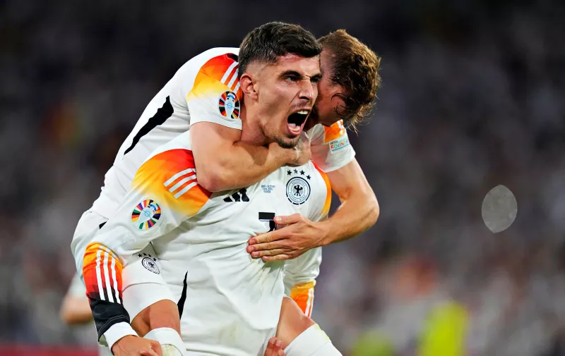 Germany's Kai Havertz celebrates with Joshua Kimmich after scoring his side's third goal during a Group A match between Germany and Scotland at the Euro 2024 soccer tournament in Munich, Germany, Friday, June 14, 2024. (AP Photo/Matthias Schrader)