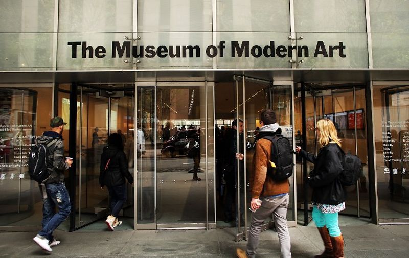 NEW YORK, NY - APRIL 11: People walk into the Museum of Modern Art (MoMA) on April 11, 2013 in New York City. MoMA announced yesterday that it will demolish the former Museum of American Folk Art, a building it purchased in 2011. The building, with a bronze sculptural facade, was architectonically acclaimed. MoMA says it needs to demolish the building in order to enlarge its own facilities.   Spencer Platt/Getty Images/AFP