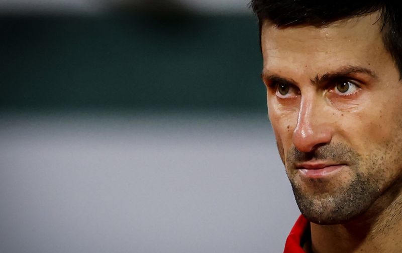 Serbia's Novak Djokovic reacts as he plays against Greece's Stefanos Tsitsipas during their men's singles semi-final tennis match on Day 13 of The Roland Garros 2020 French Open tennis tournament in Paris on October 9, 2020. (Photo by Thomas SAMSON / AFP)