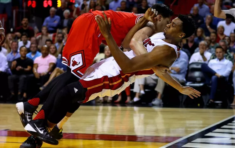 MIAMI, FLORIDA - APRIL 07: Hassan Whiteside #21 of the Miami Heat is fouled by Doug McDermott #3 of the Chicago Bulls during a game at American Airlines Arena on April 7, 2016 in Miami, Florida. NOTE TO USER: User expressly acknowledges and agrees that, by downloading and or using this photograph, User is consenting to the terms and conditions of the Getty Images License Agreement.   Mike Ehrmann/Getty Images/AFP