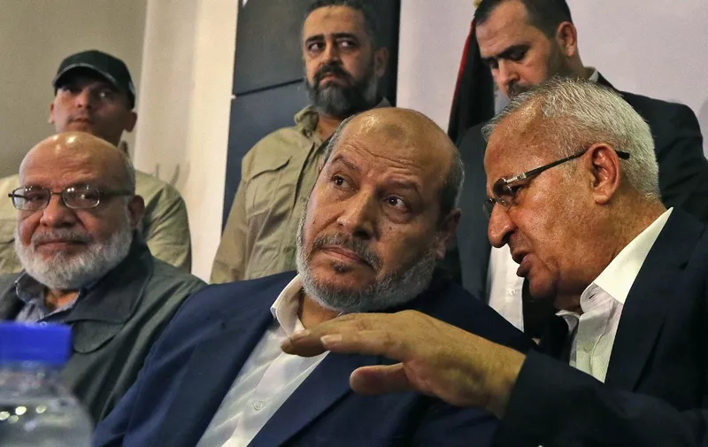 Senior official of the Palestinian Islamic Jihad movement, Abdulaziz al-Minawi (L), Hamas Arab relations chief Khalil al-Hayya (C), and secretary general of the Popular Front for the Liberation of Palestine-General Command, Talal Naji, hold a press conference during a visit to the Syrian capital Damascus on October 19, 2022 for the first time since the Palestinian Islamist group severed ties with Syria a decade ago. Palestinian movement Hamas said it restored relations with the Damascus government after a visiting delegation held a "historic meeting" with President Bashar al-Assad in Syria's capital. The group, which controls the Gaza Strip, was one of Assad's closest allies but it left Syria in 2012 after condemning his government's brutal suppression of protests in March 2011, which triggered the country's descent into civil war. (Photo by LOUAI BESHARA / AFP)