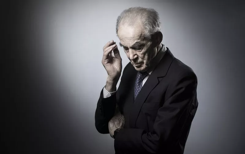 (FILES) Former French Justice Minister Robert Badinter poses in his office during a photo session in Paris on April 19, 2018. Former French justice minister Robert Badinter, who in 1981 brought an end to capital punishment in France, has died aged 95, his aide Aude Napoli told AFP on February 9, 2024. Badinter, who also served as head of France's highest administrative instance the Constitutional Council, died overnight, she said. Months after taking office under Socialist President Francois Mitterrand, Badinter successfully brought a law before parliament prohibiting capital punishment. Executions had been carried out with the guillotine. (Photo by JOEL SAGET / AFP)