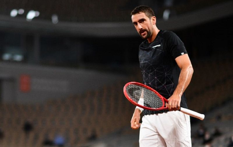 Croatia's Marin Cilic reacts as he plays against Austria's Dominic Thiem during their men's singles first round tennis match at the Philippe Chatrier court on Day 2 of The Roland Garros 2020 French Open tennis tournament in Paris on September 28, 2020. (Photo by Martin BUREAU / AFP)