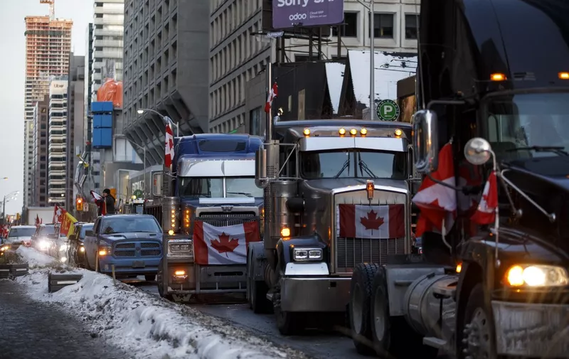 (FILES) In this file photo taken on February 5, 2022  trucks line Bloor near Yorkville in Toronto, Canada. A convoy of truckers and supporters have occupied downtown Ottawa since last Saturday in protest of Canada's COVID-19 vaccine mandate, with convoys branching out to other major cities such as Toronto this weekend. - The ongoing truckers' protest in the Canadian capital is now "completely out of control," the Ottawa mayor said February 6, 2022 as the city center remained blocked by opponents of anti-Covid measures. (Photo by Cole Burston / GETTY IMAGES NORTH AMERICA / AFP)