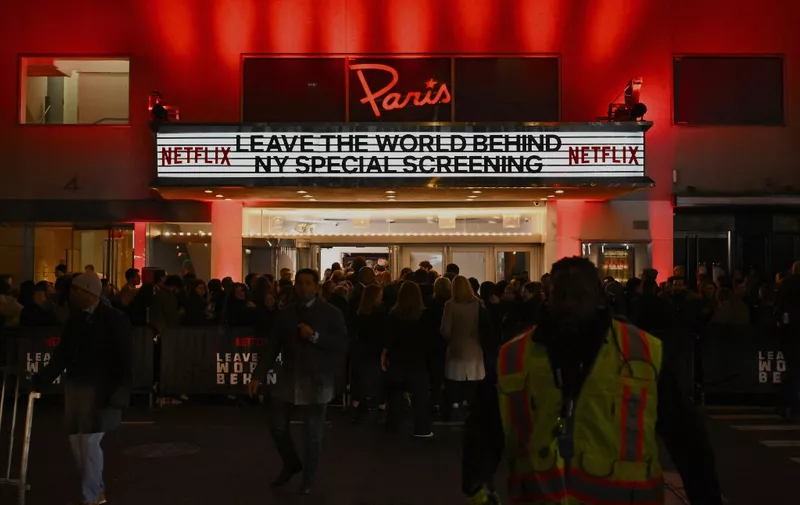 Fans and guests stand outside the Paris Theater during Netflix's "Leave The World Behind" premiere in New York City on December 4, 2023. (Photo by ANGELA WEISS / AFP)