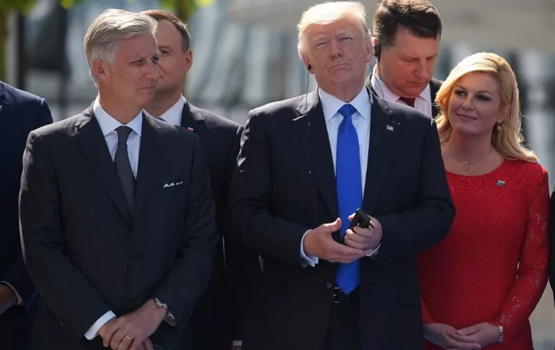 (L-R) King Philippe - Filip of Belgium, US President Donald Trump and Croatian President Kolinda Grabar-Kitarovic attend the unveiling ceremony of the Berlin Wall monument, during the NATO (North Atlantic Treaty Organization) summit at the NATO headquarters, in Brussels, on May 25, 2017.  / AFP PHOTO / MANDEL NGAN