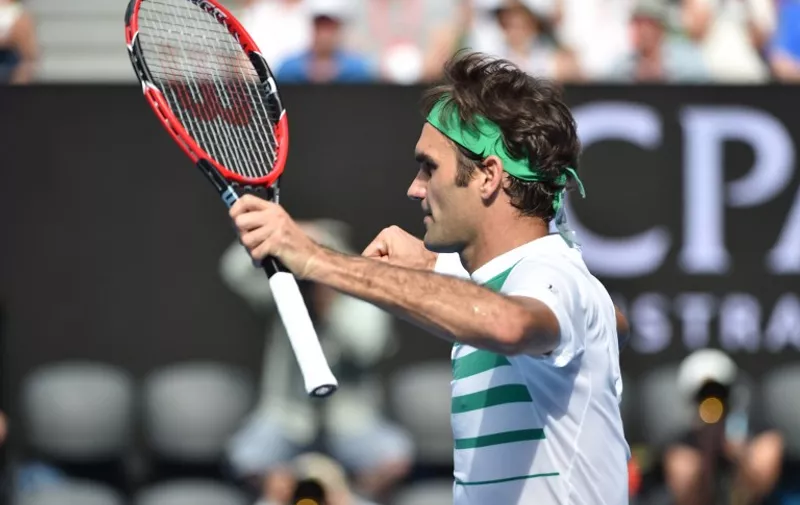 Switzerland's Roger Federer celebrates victory during his men's singles match against Czech Republic's Tomas Berdych on day nine of the 2016 Australian Open tennis tournament in Melbourne on January 26, 2016. AFP PHOTO / SAEED KHAN -- IMAGE RESTRICTED TO EDITORIAL USE - STRICTLY NO COMMERCIAL USE / AFP / SAEED KHAN