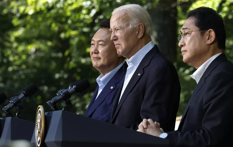 CAMP DAVID, MARYLAND - AUGUST 18: (L-R) South Korean President Yoon Suk Yeol, U.S. President Joe Biden and Japanese Prime Minister Kishida Fumio hold a joint news conference following three-way talks at Camp David on August 18, 2023 in Camp David, Maryland. Biden hosted the trilateral summit at the presidential retreat near Thurmont, Maryland, where the leaders discussed moving forward in "lockstep" on issues related to military cooperation, international politics, countering China and North Korea and other topics.   Chip Somodevilla/Getty Images/AFP (Photo by CHIP SOMODEVILLA / GETTY IMAGES NORTH AMERICA / Getty Images via AFP)