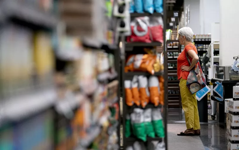 A shopper walks through a grocery store in Washington, DC, on June 14, 2022. (Photo by Stefani Reynolds / AFP)