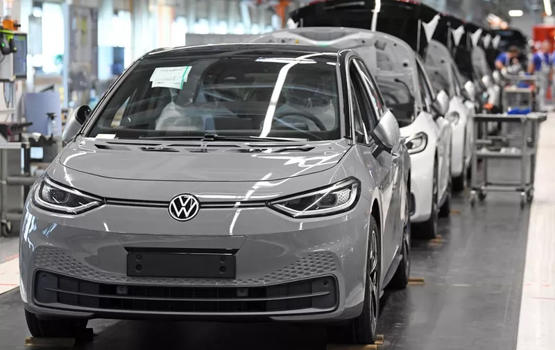 (FILES) Almost finished Volkswagen ID.3 electric cars are seen at the end of the assembly line at the plant of German car maker Volkswagen (VW) in Zwickau, eastern Germany, after production restarted on April 23, 2020 amid the novel coronavirus COVID-19 pandemic. Volkswagen is cutting almost 300 temporary jobs at its flagship electric car plant in Zwickau as it struggles to gain a foothold in the EV market, the IG Metall union said on September 14, 2023. (Photo by Hendrik Schmidt / POOL / AFP)