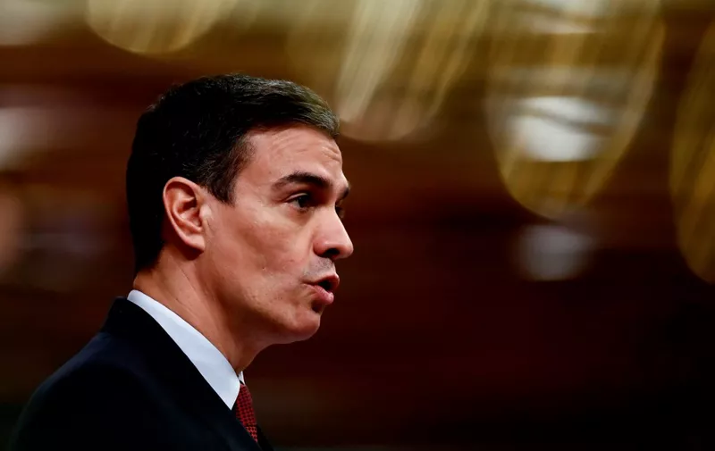 Spanish Prime Minister Pedro Sanchez delivers a speech during a session at the Lower Chamber in Madrid on March 25, 2020 to debate the extension of a national lockdown until April 11 in an effort to slow down the spread of the COVID-19 coronavirus. - As the global death toll soared past 20,000, Spain joined Italy in seeing its number of fatalities overtake China, where the virus first emerged just three three months ago. (Photo by Mariscal / various sources / AFP)