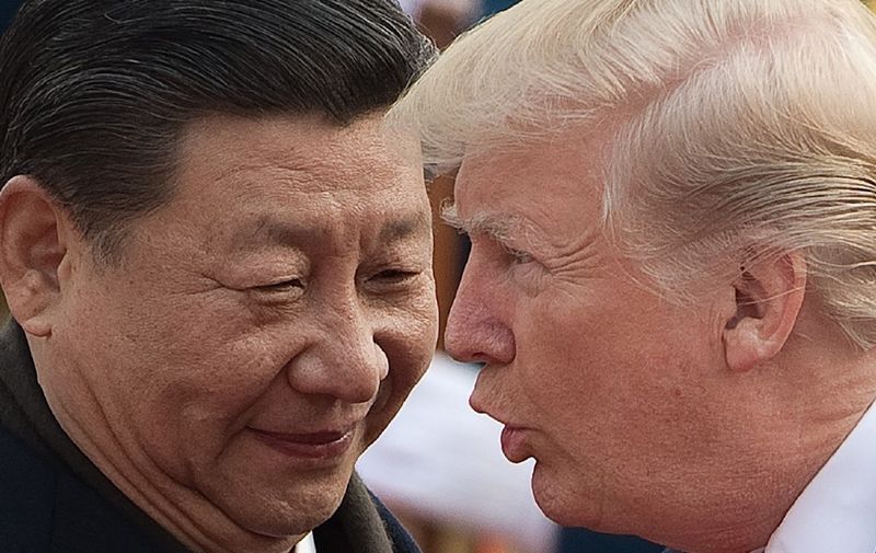 China's President Xi Jinping (L) and US President Donald Trump attend a welcome ceremony at the Great Hall of the People in Beijing on November 9, 2017. (Photo by NICOLAS ASFOURI / AFP)