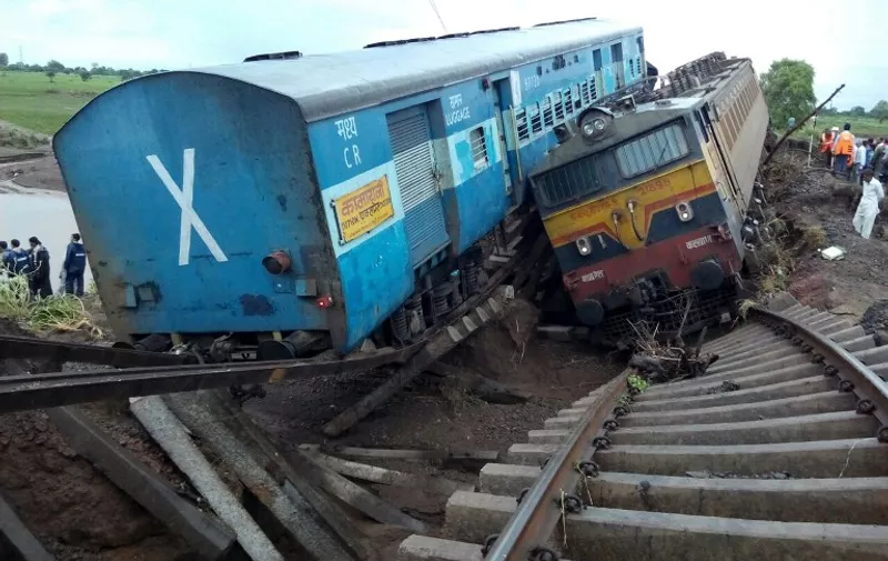 Two Indian passenger trains lay next to each other following a derailment after they were hit by flash floods on a bridge outside the town of Harda in Madhya Pradesh state on August 5, 2015. Two passenger trains derailed after being hit by flash floods on a bridge in central India, killing at least 27 people in the latest deadly accident on the nation's crumbling rail network. AFP PHOTO