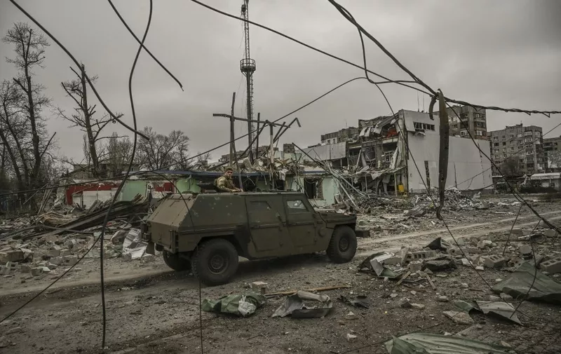 EDITORS NOTE: Graphic content / A military vehicle drives through an area destroyed after a strike, in the city of Avdiivka, Donetsk Oblast, on March 18, 2023. (Photo by Aris Messinis / AFP)