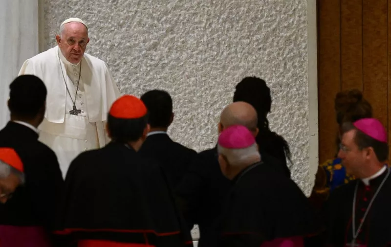 Pope Francis walks past cardinals and bishops as he arrives for the weekly general audience on December 7, 2022 at Paul-VI hall in The Vatican. (Photo by Vincenzo PINTO / AFP)